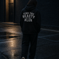 Model wearing the Find the Beauty in the Blur hoodie in a rain-soaked parking lot